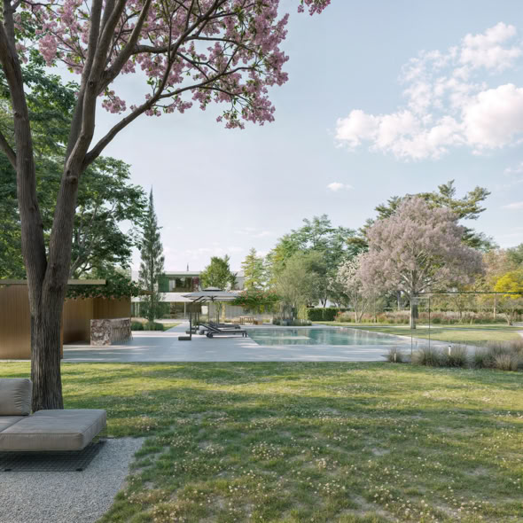 Vista sul giardino privato, in cui la vegetazione mediterranea incornicia la villa, creando un equilibrio tra architettura e natura.