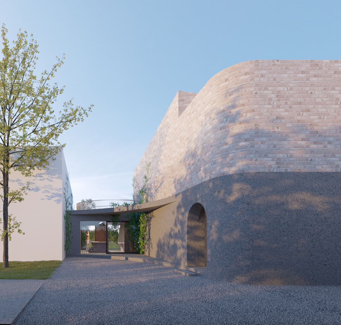 Vista frontale dell’edificio con geometria irregolare e dialogo con la vegetazione.