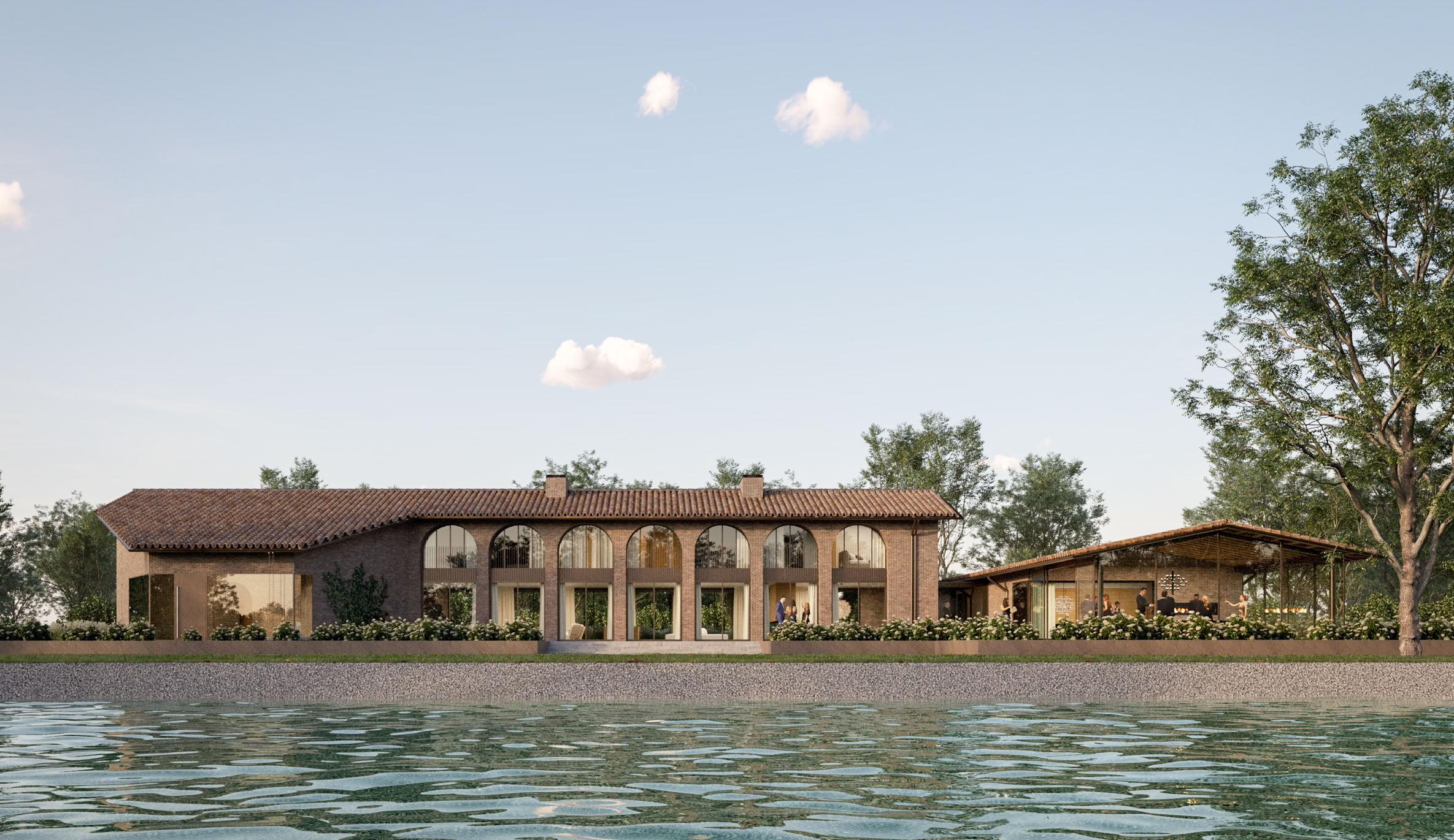 Prospetto della villa immersa nelle campagne venete, con materiali naturali e linee essenziali