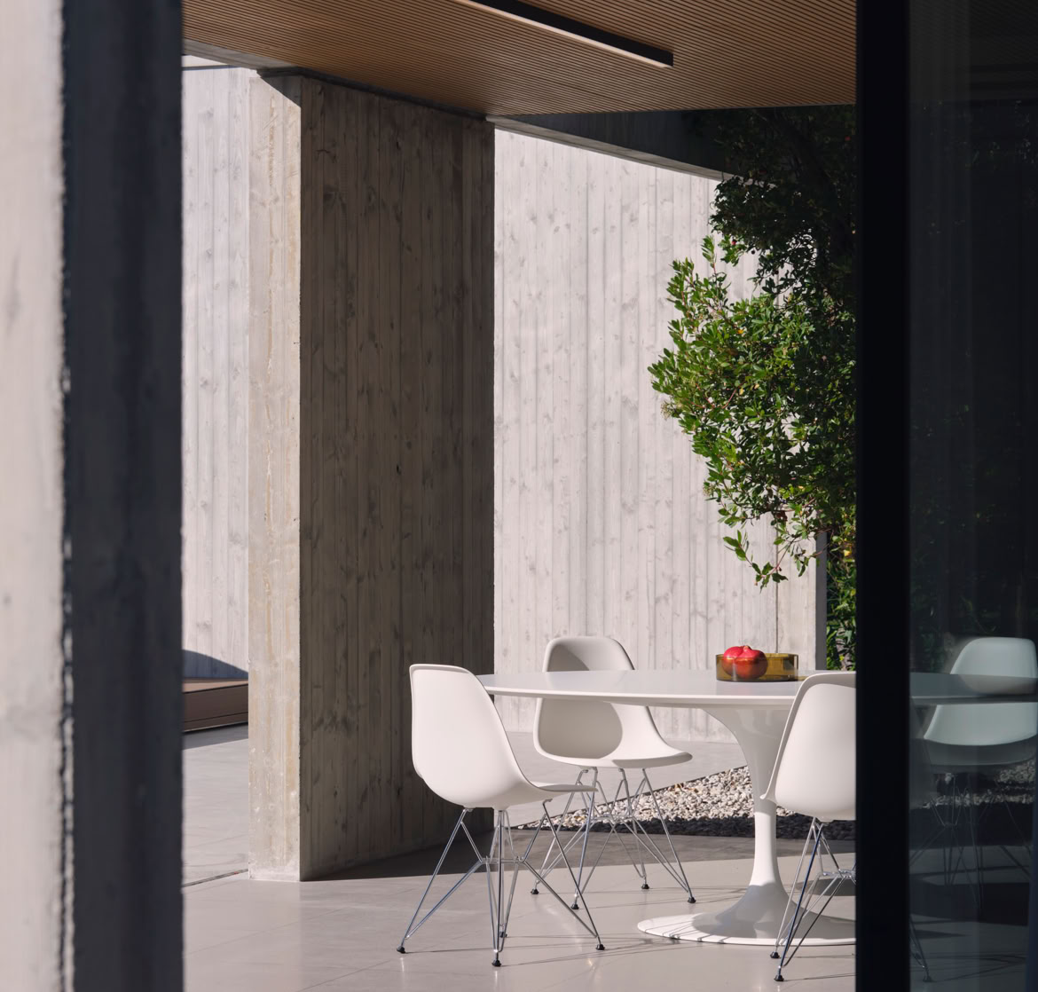 Vista del portico esterno della villa a San Donà di Piave progettata da MIDE architetti immersa nel verde e disegnata con geometrie pulite che regalano privacy all'abitazione.